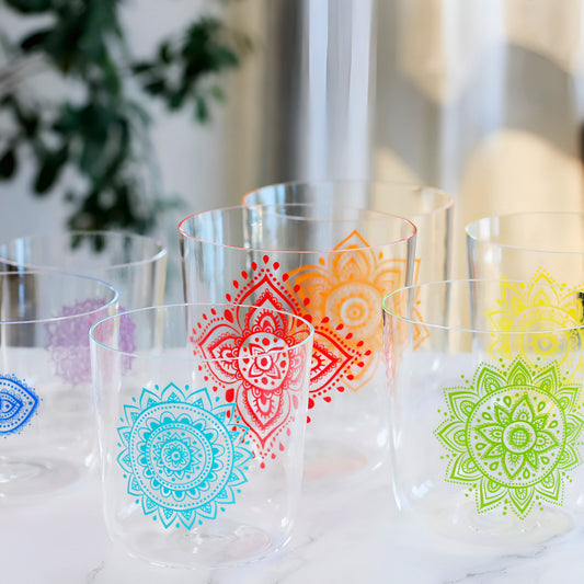 Glass tumblers set with vibrant chakra mandala patterns in multiple colors
