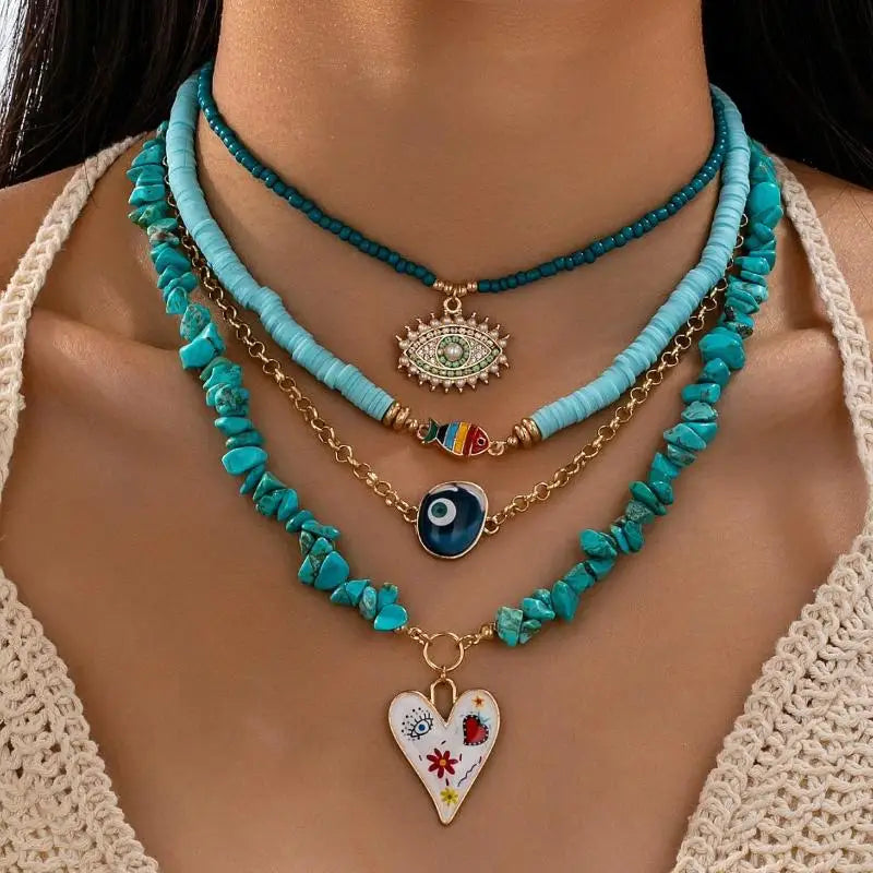Necklace with various pendants on a person wearing a beige top | DIVINE TIMES by Shopp Java