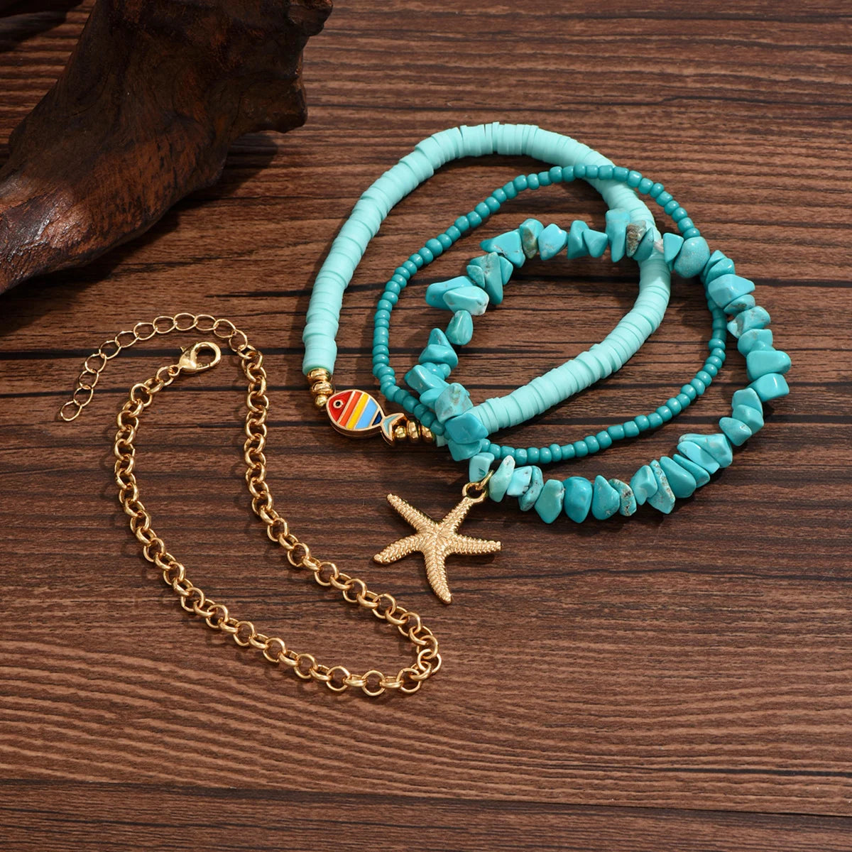 DIVINE TIMES by Shopp Java four-piece turquoise chip and clay bead anklet set with starfish and fish charms.